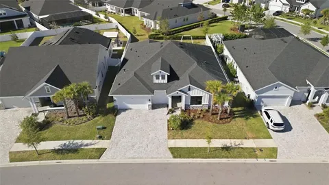 an aerial view of a house with a yard