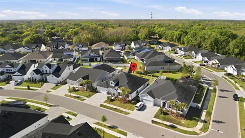 an aerial view of residential houses with outdoor space and river