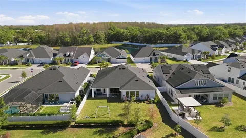 an aerial view of a house with outdoor space and lake view
