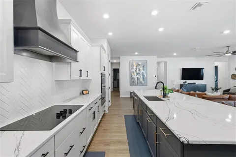 a kitchen with stainless steel appliances a sink stove and cabinets
