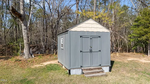 a living room with furniture a ceiling fan and a window