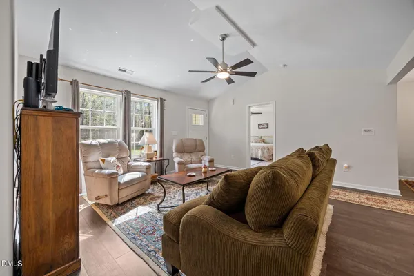 a bathroom with a sink a toilet and shower curtain