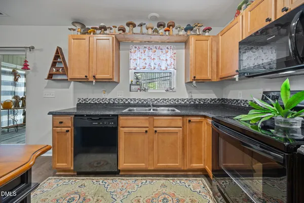 an aerial view of lake residential house with outdoor space and trees around
