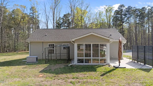 a view of a backyard with table and chairs and wooden fence