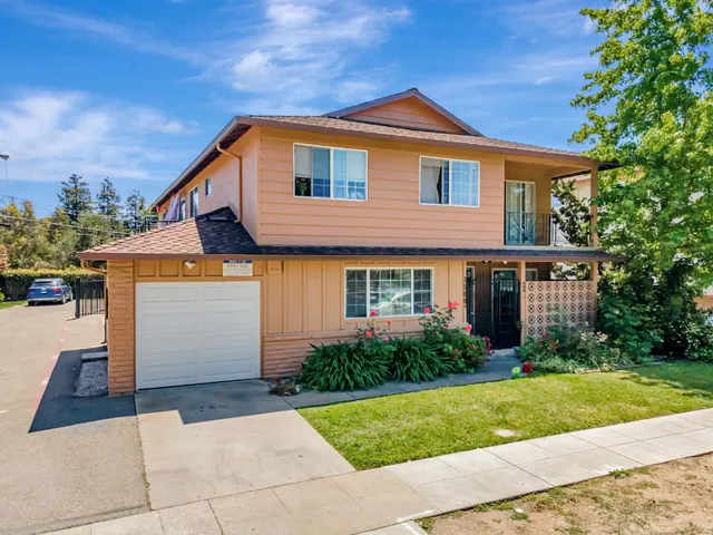 a front view of a house with garden