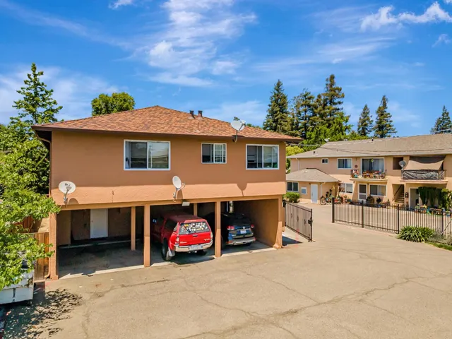 a view of a patio with a table and chairs under an umbrella