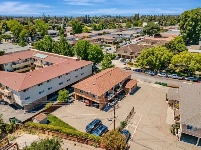 an aerial view of a house with a yard