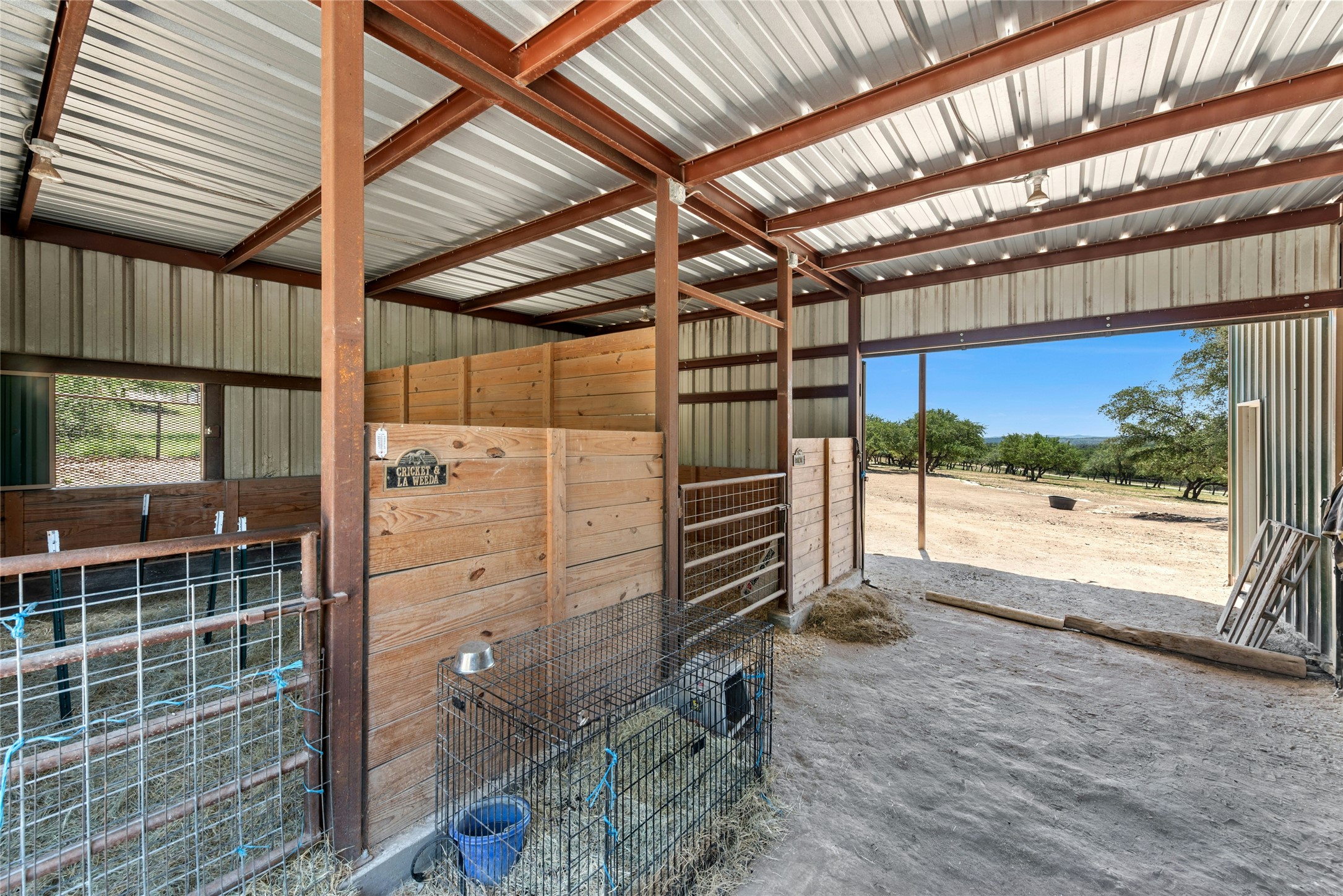 496 Middleton Road Spicewood, TX 78669 - Photo 30 of 40 Open-air barn structure featuring a metal roof and exposed steel beams