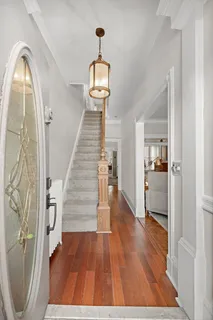 a hallway with a wooden floor and a bedroom