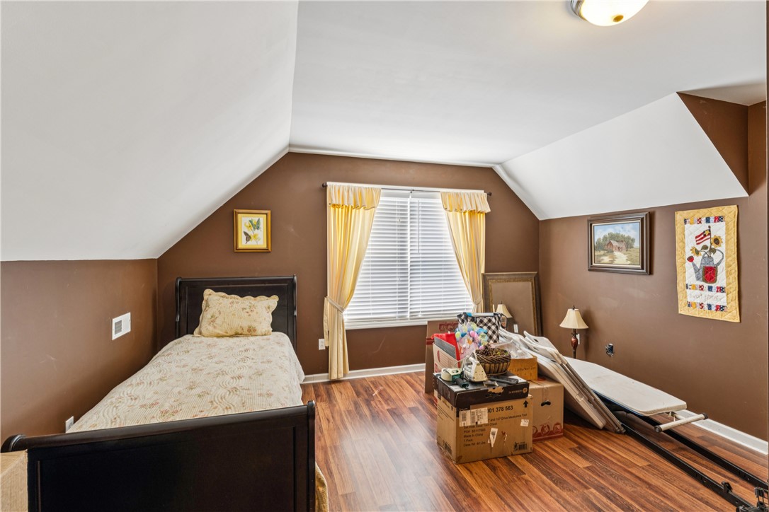 189 Little Choestoea Road Westminster, SC 29693 - Photo 24 of 38 This cozy bedroom features sloped ceilings and durable flooring, offering a comfortable and adaptable personal space.