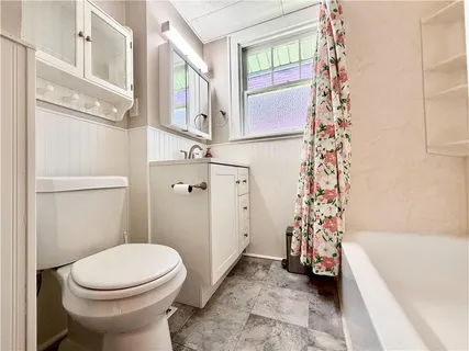 a bathroom with a toilet a sink and a bathtub