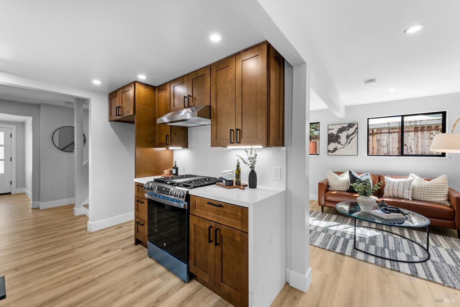 2192 First Avenue Napa, CA 94558 - Photo 19 of 81 a kitchen with stainless steel appliances granite countertop a stove top oven a sink dishwasher and wooden cabinets with wooden floor