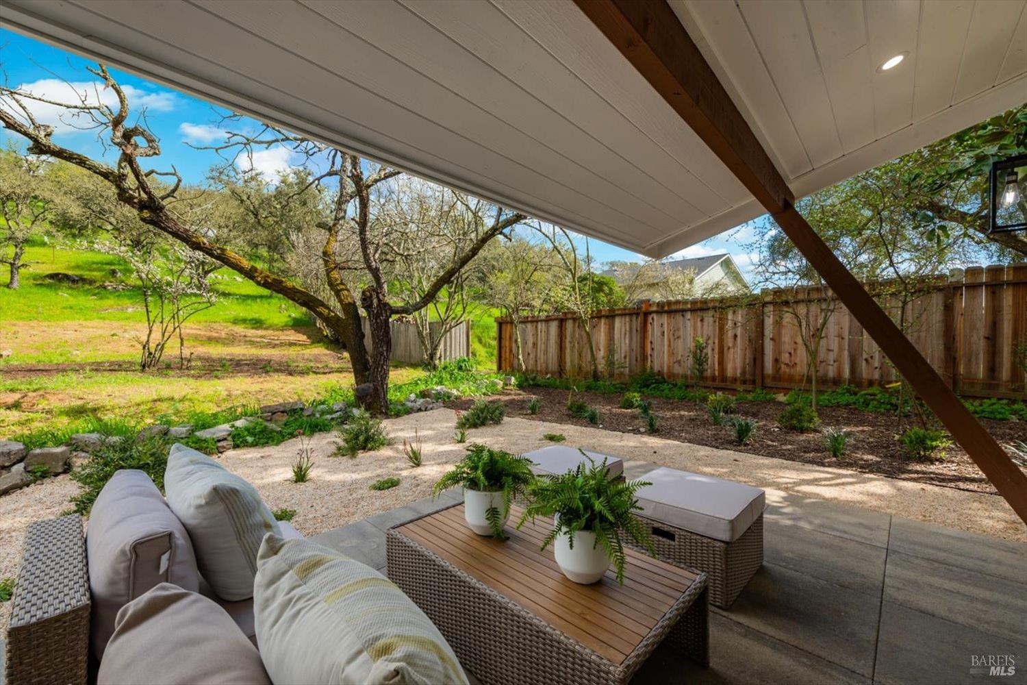 2192 First Avenue Napa, CA 94558 - Photo 53 of 81 a view of a patio with couches chairs potted plants and a large tree