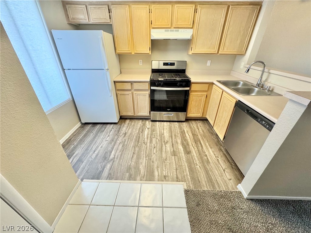 8070 West Russell Road, Unit 2121 Las Vegas, NV 89113 - Photo 4 of 22 Functional kitchen with light wood cabinetry and resilient flooring offers practical culinary space.