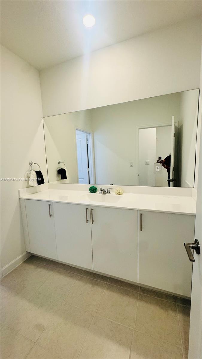 19479 Southwest 340th Street, Unit 1 Homestead, FL 33034 - Photo 11 of 58 a bathroom with a double vanity sink and mirror