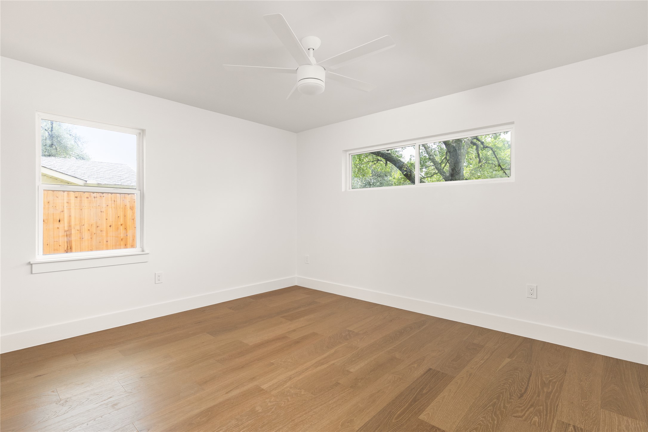 4501 Pack Saddle Pass Austin, TX 78745 - Photo 31 of 37 Spacious room featuring wood-finish flooring, crisp white walls, and a contemporary ceiling fan