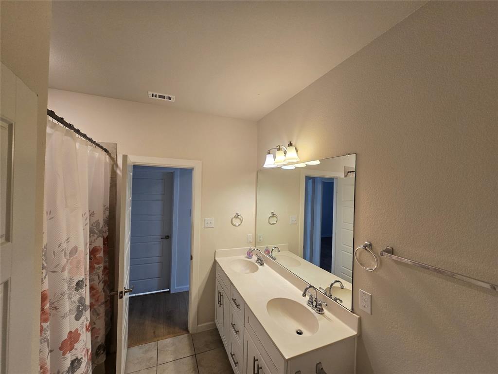 508 Williams Way Van Alstyne, TX 75495 - Photo 17 of 26 a bathroom with a sink and a mirror