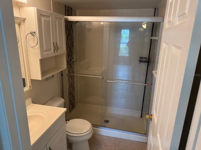 a bathroom with a toilet and a shower