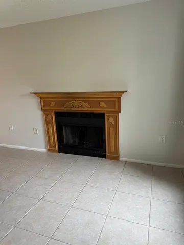 a view of empty room with a fireplace