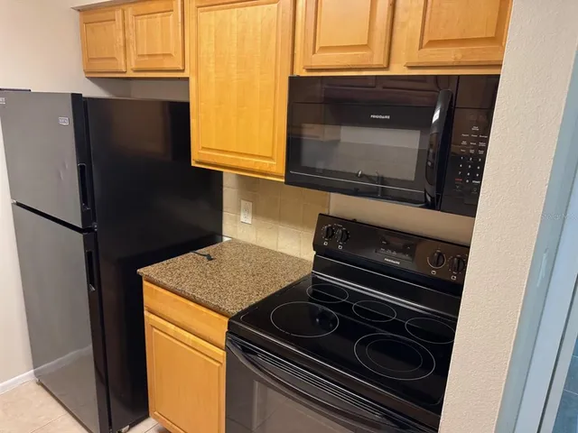 a kitchen with a stove and a microwave