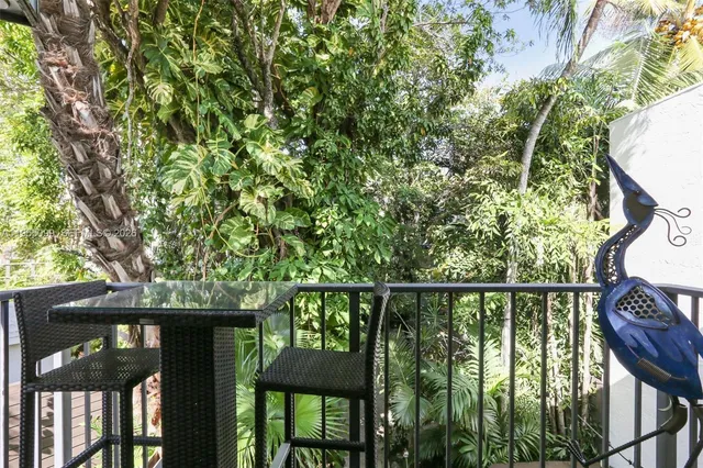 a view of a wooden deck and a forest