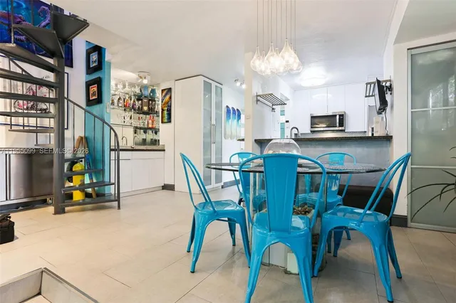 a view of a dining room with furniture and a chandelier