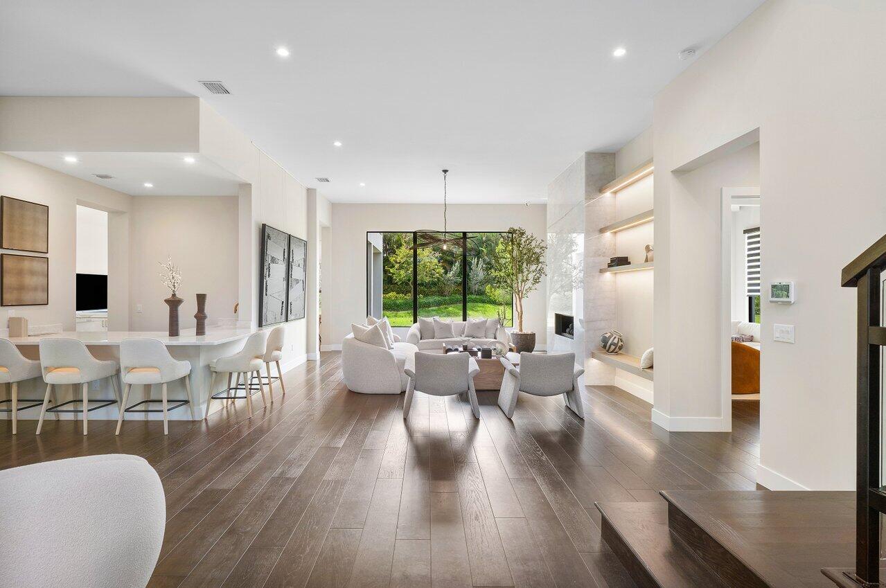 17464 Ponte Chiasso Drive Boca Raton, FL 33496 - Photo 4 of 37 a living room with furniture large window and wooden floor