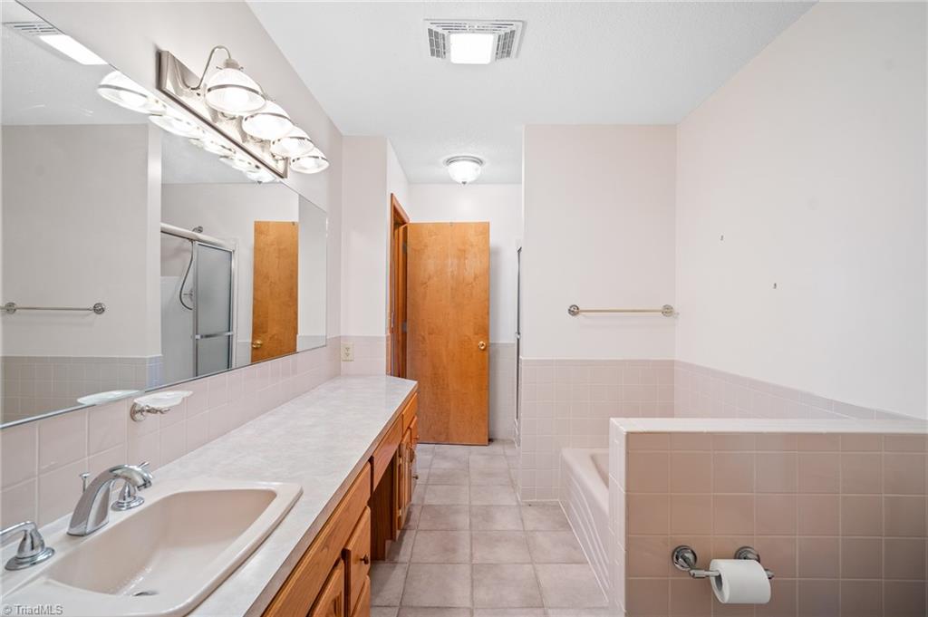 1210 Jones Road King, NC 27021 - Photo 18 of 30 Primary bedroom offers separate tub and shower.