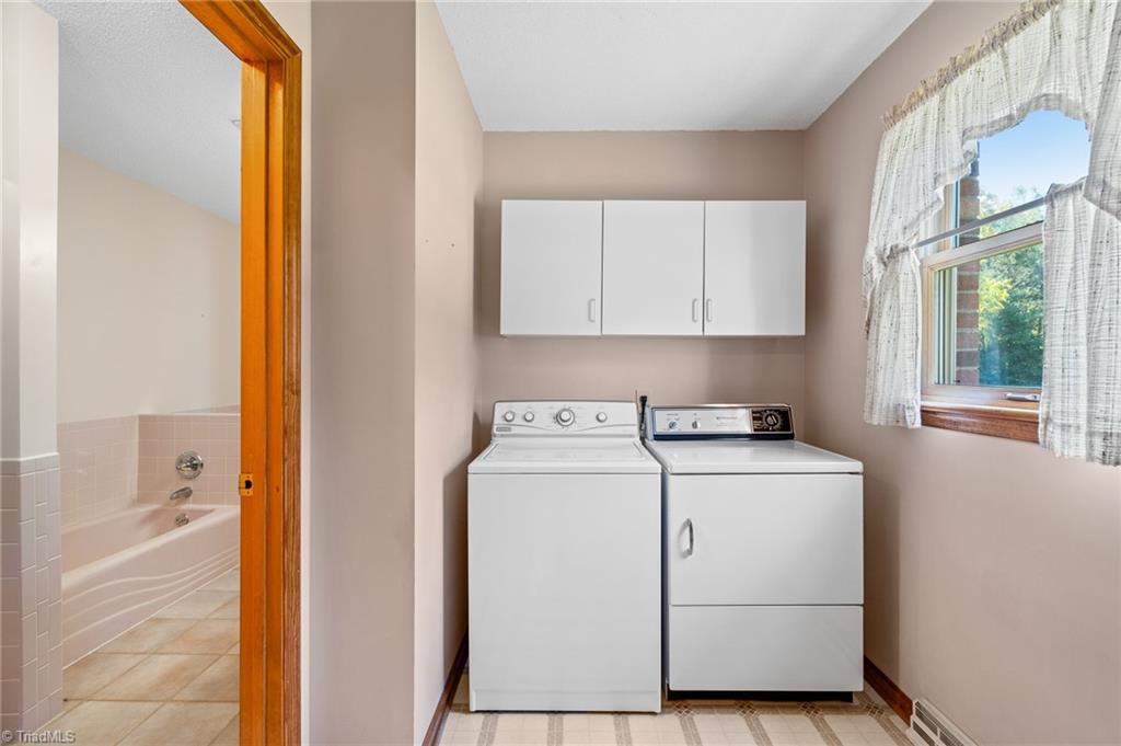 1210 Jones Road King, NC 27021 - Photo 19 of 30 Laundry is located off the primary bath and can be easily accessed through the kitchen as well.