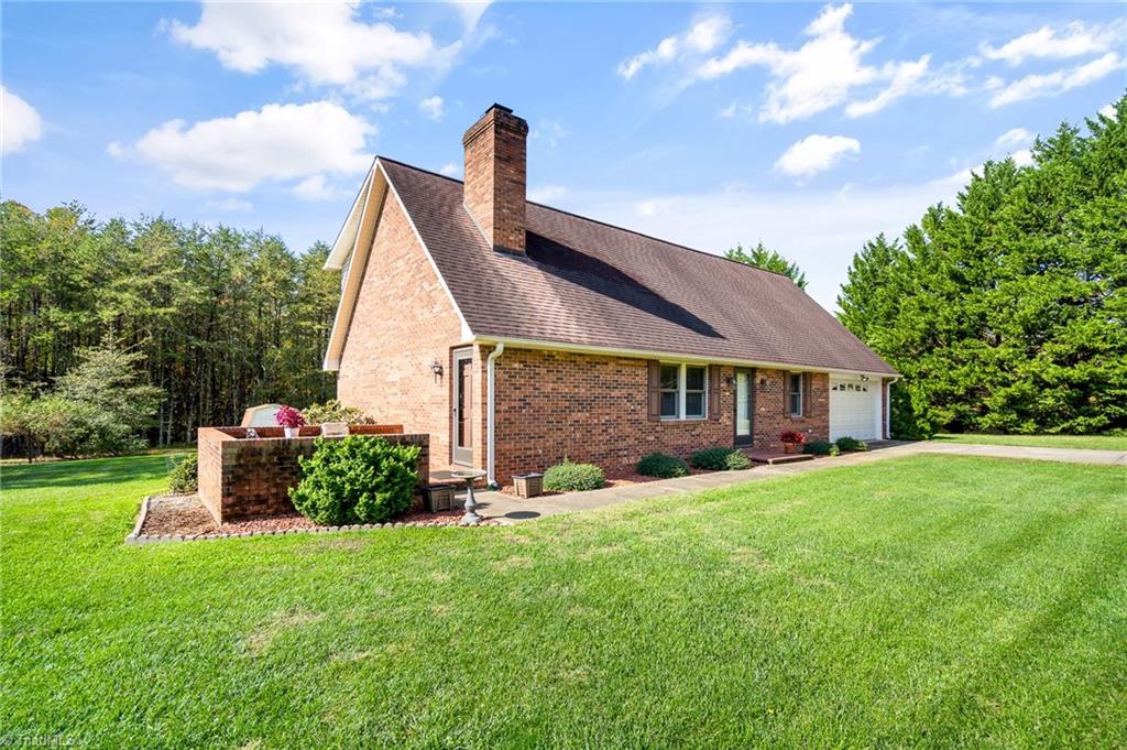 1210 Jones Road King, NC 27021 - Photo 2 of 30 This home offers a beautiful brick patio and sits right in the middle of the lot.