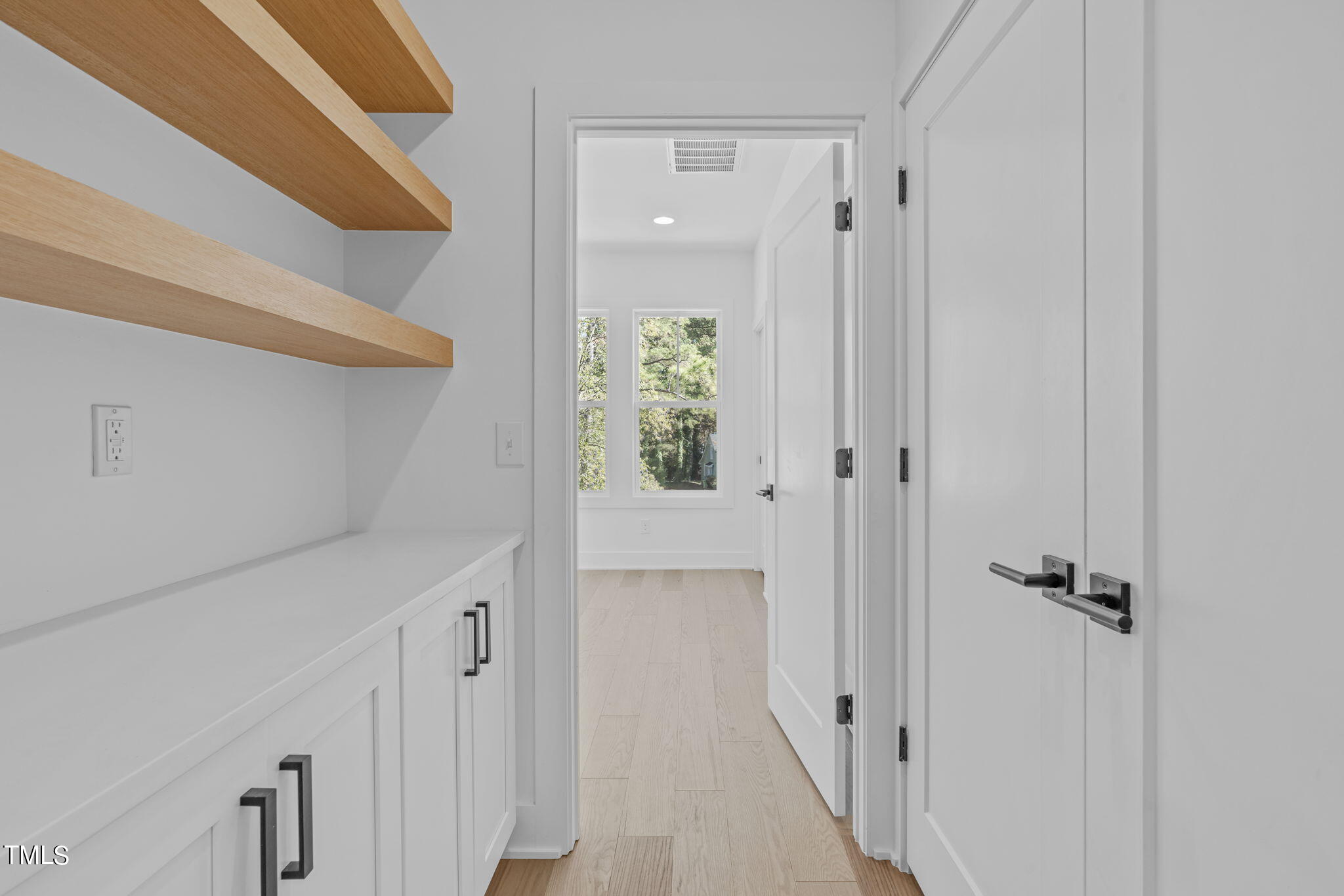 853 Athens Drive, Unit 101 Raleigh, NC 27606 - Photo 30 of 61 a view of a hallway with wooden floor and staircase