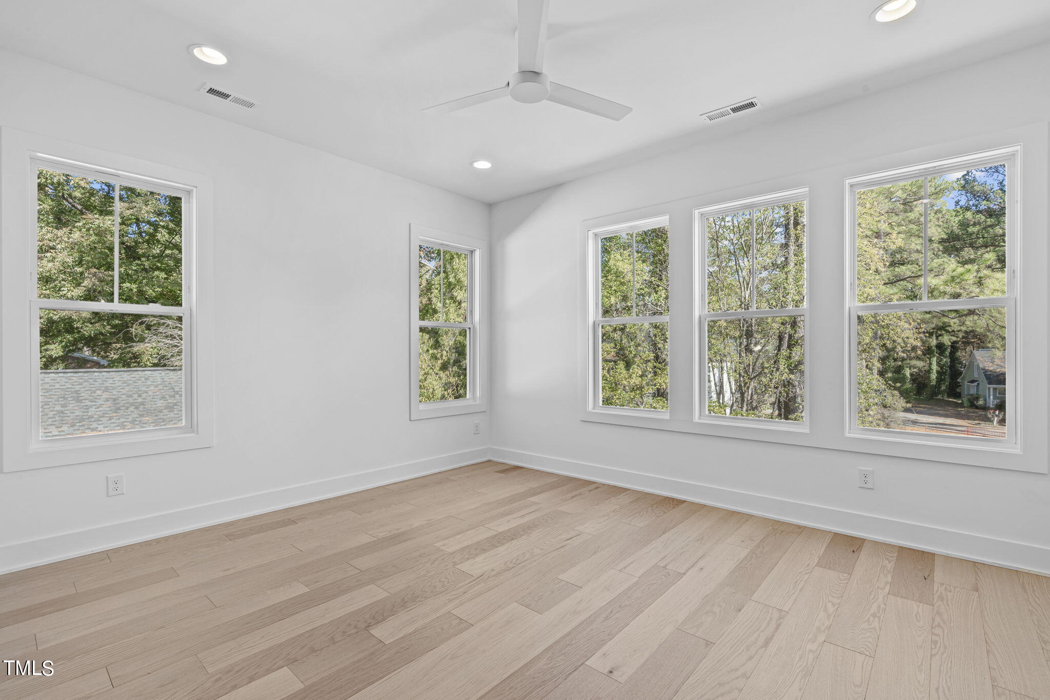 853 Athens Drive, Unit 101 Raleigh, NC 27606 - Photo 31 of 61 a view of an empty room with wooden floor and a window