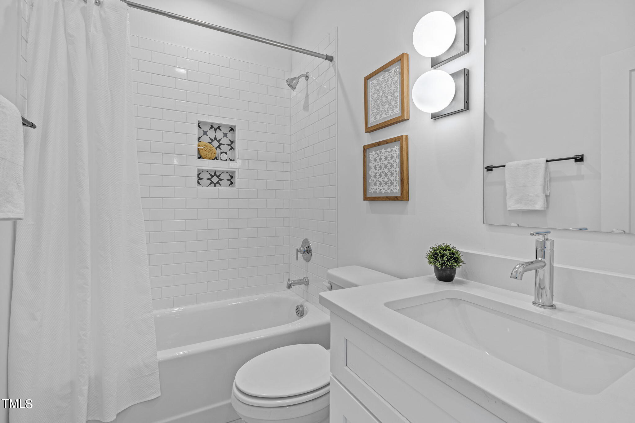 853 Athens Drive, Unit 101 Raleigh, NC 27606 - Photo 38 of 61 a bathroom with a toilet sink vanity tub and mirror
