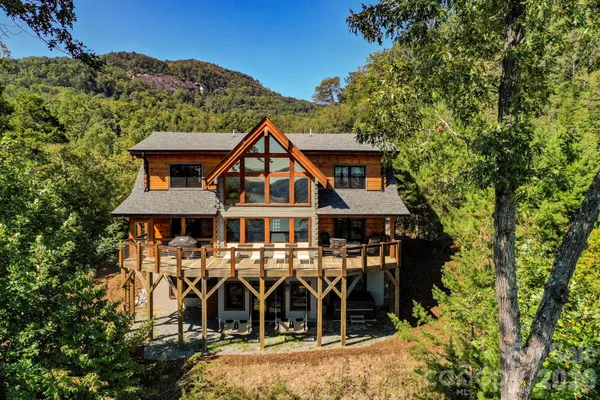 an aerial view of lake residential house with outdoor space and trees around