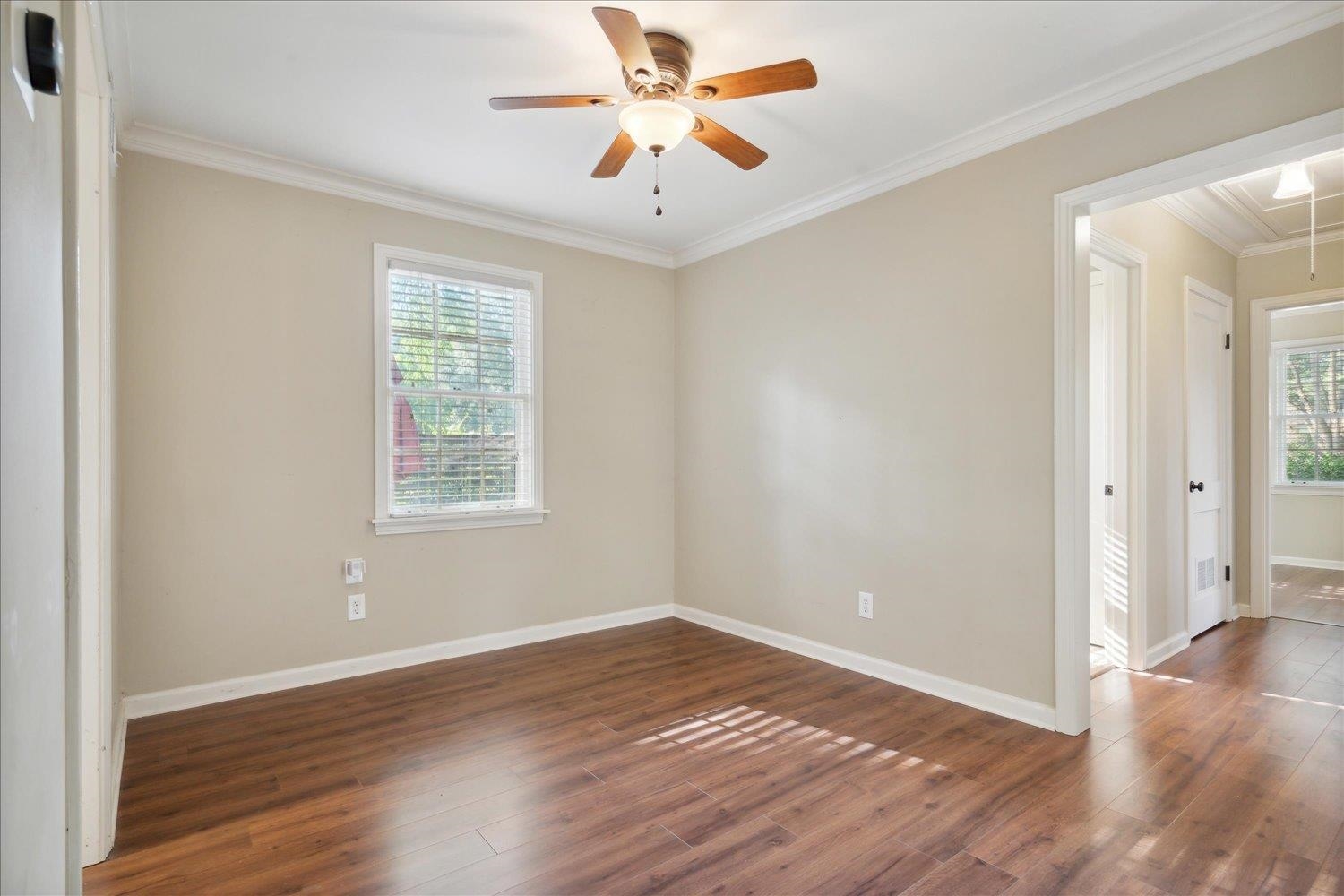 964 Ivy Road Memphis, TN 38117 - Photo 11 of 33 an empty room with wooden floor and windows