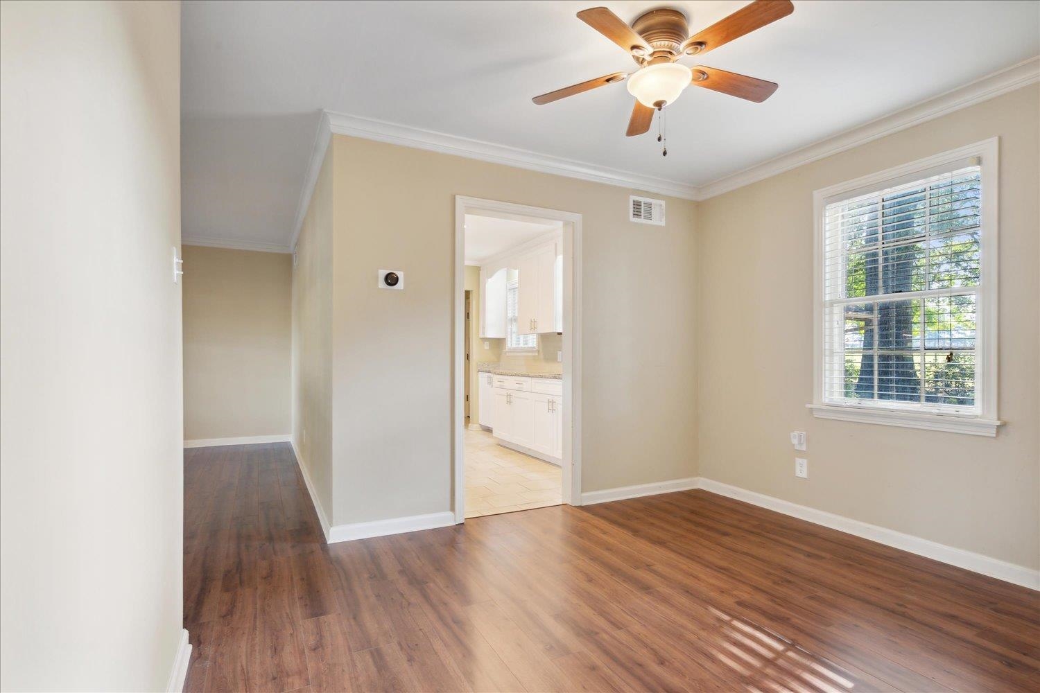 964 Ivy Road Memphis, TN 38117 - Photo 12 of 33 a view of an empty room with window and wooden floor