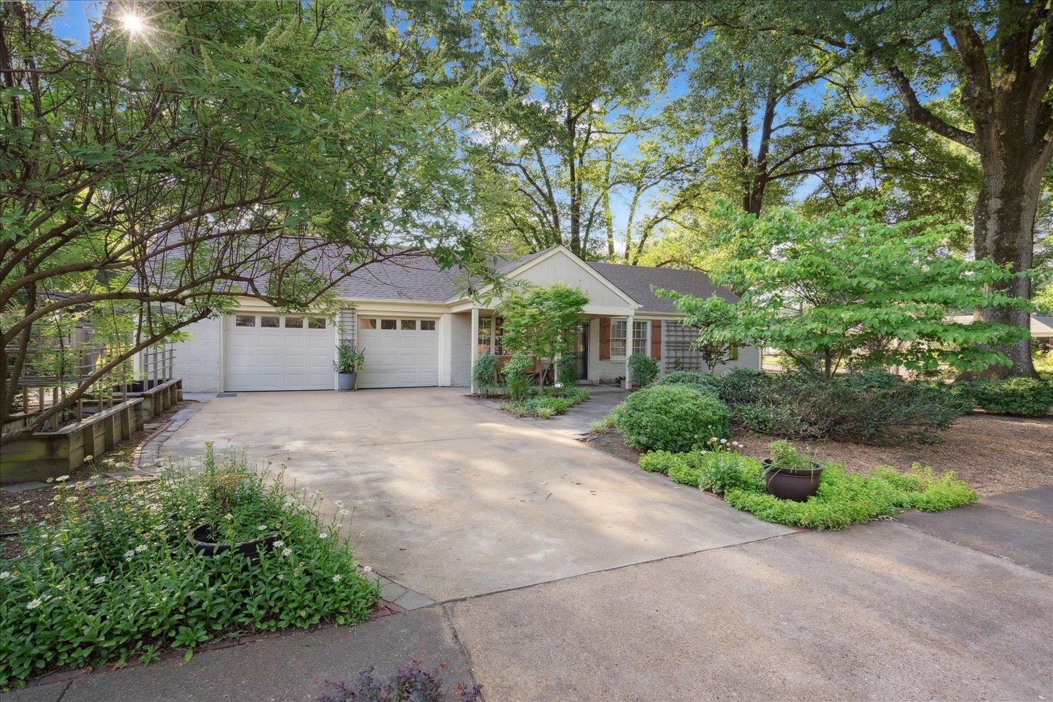 964 Ivy Road Memphis, TN 38117 - Photo 2 of 33 a front view of a house with a yard and garage