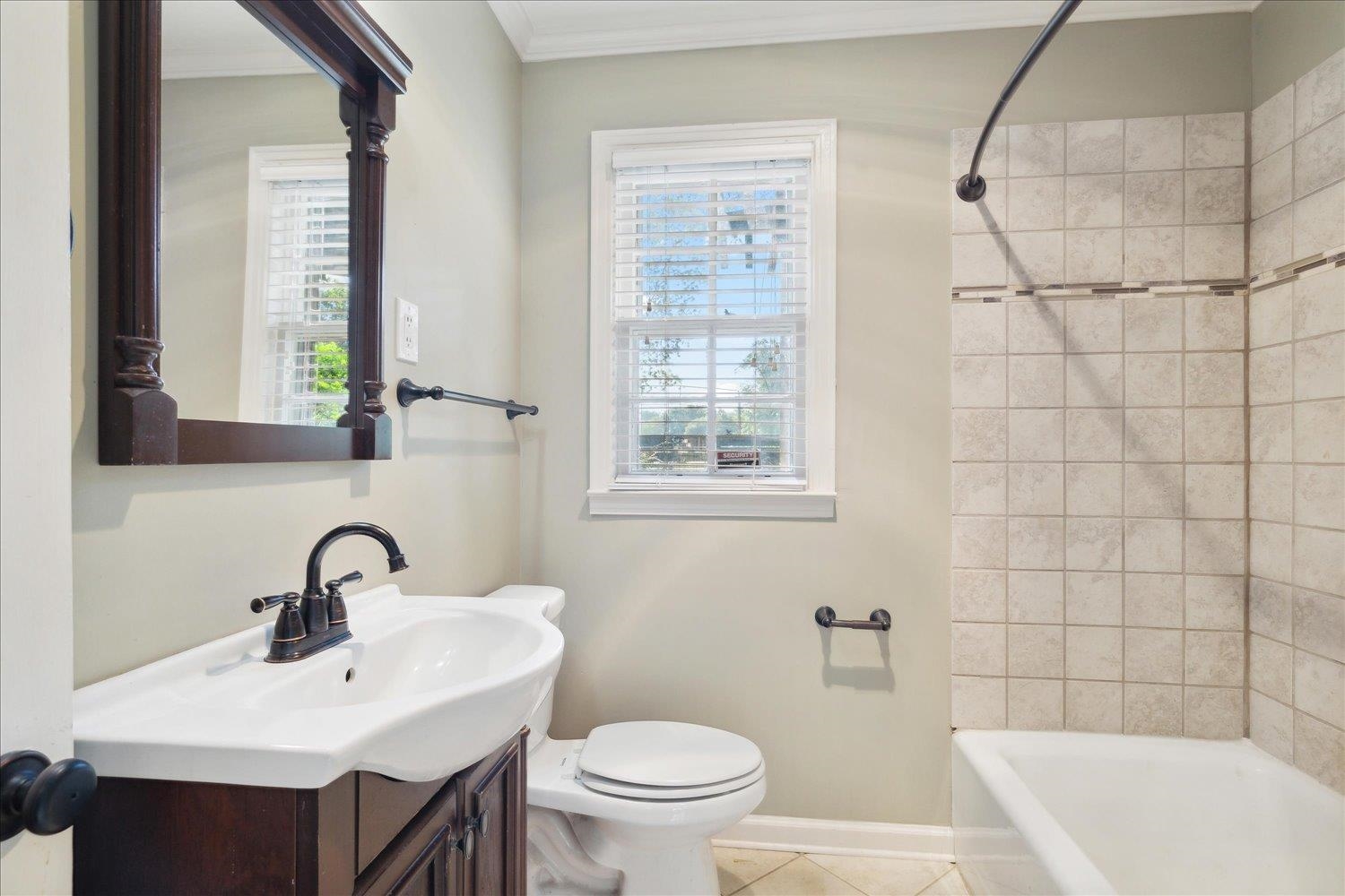 964 Ivy Road Memphis, TN 38117 - Photo 21 of 33 a bathroom with a sink a toilet and a mirror