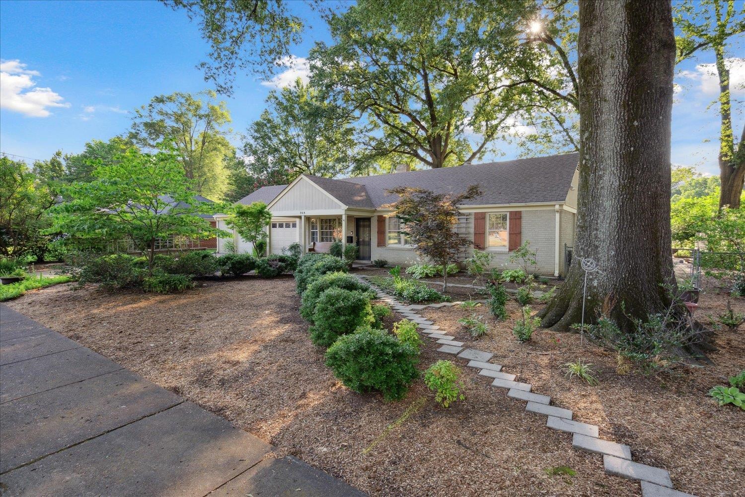 964 Ivy Road Memphis, TN 38117 - Photo 4 of 33 a front view of a house with a yard