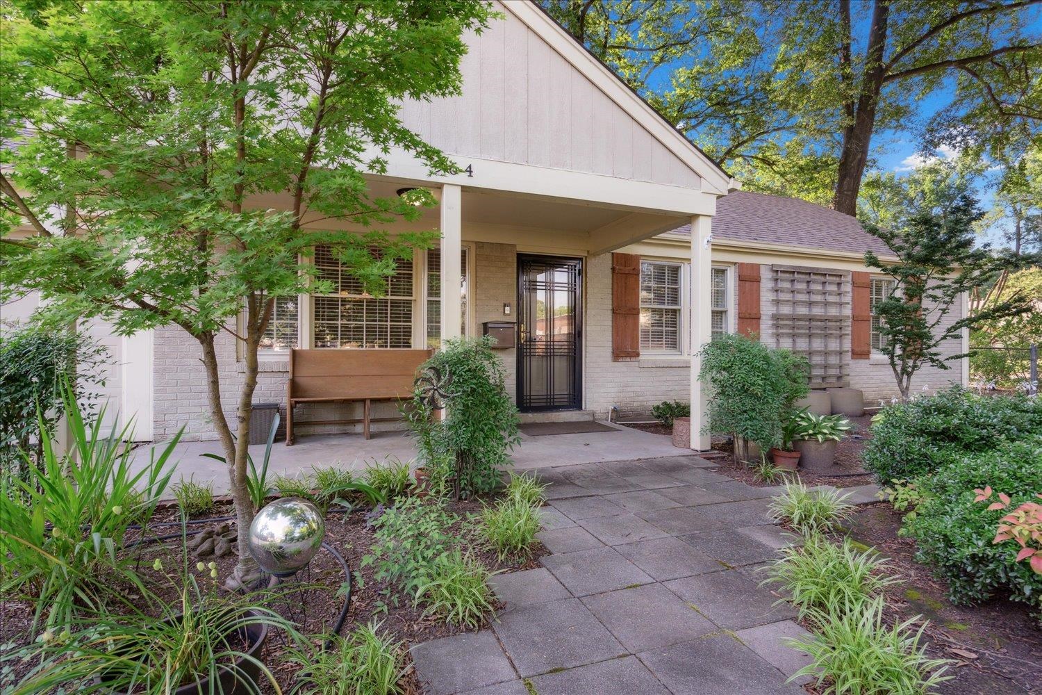 964 Ivy Road Memphis, TN 38117 - Photo 6 of 33 a view of a house with potted plants and a large tree