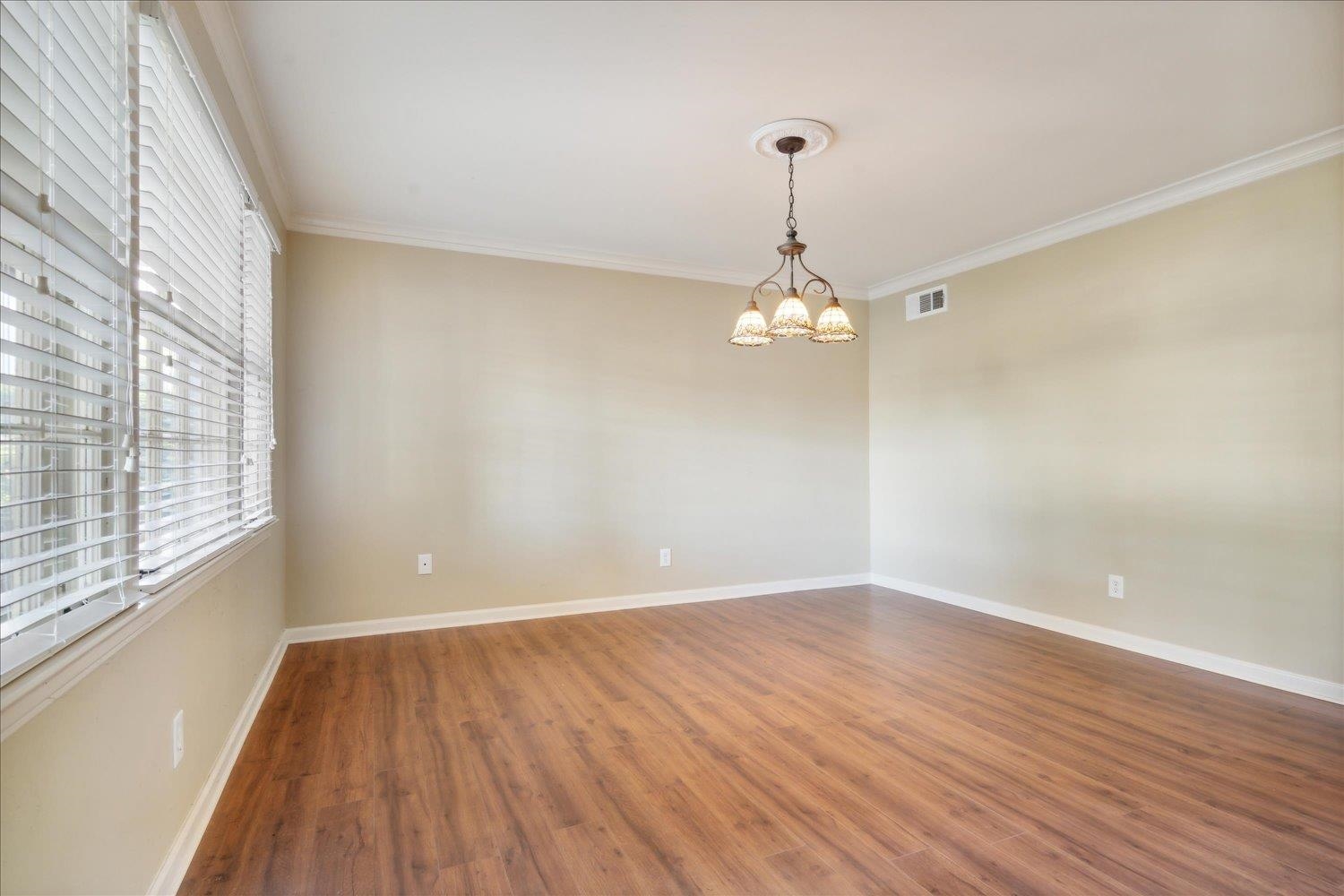 964 Ivy Road Memphis, TN 38117 - Photo 9 of 33 wooden floor in an empty room with a window