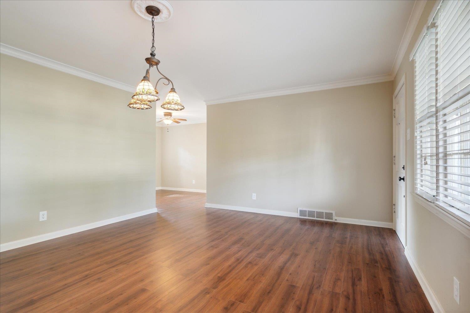 964 Ivy Road Memphis, TN 38117 - Photo 10 of 33 wooden floor in an empty room with a window