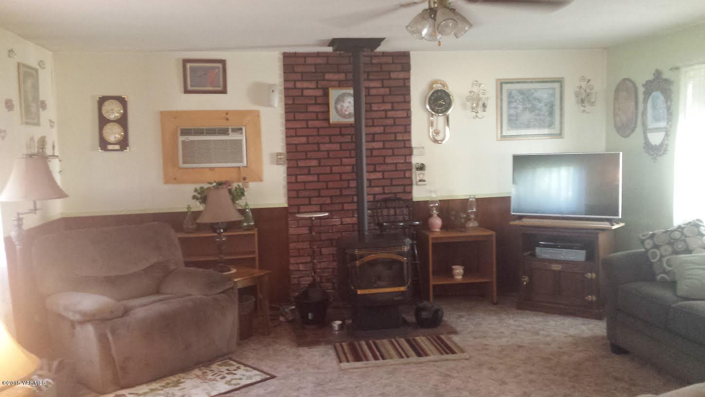 5490 Lateral A Road Wapato, WA 98951 - Photo 4 of 11 a living room with furniture and a fireplace