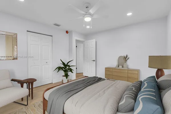a bedroom with a bed and ceiling fan