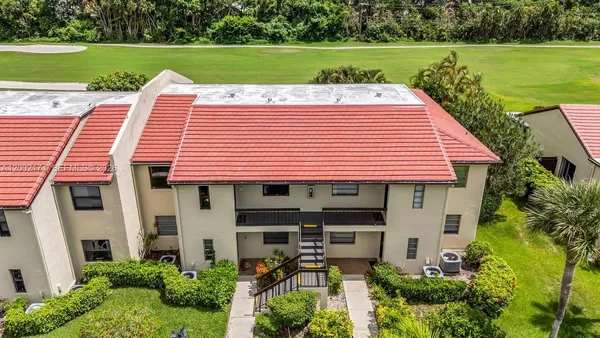 a view of a house with backyard and a patio