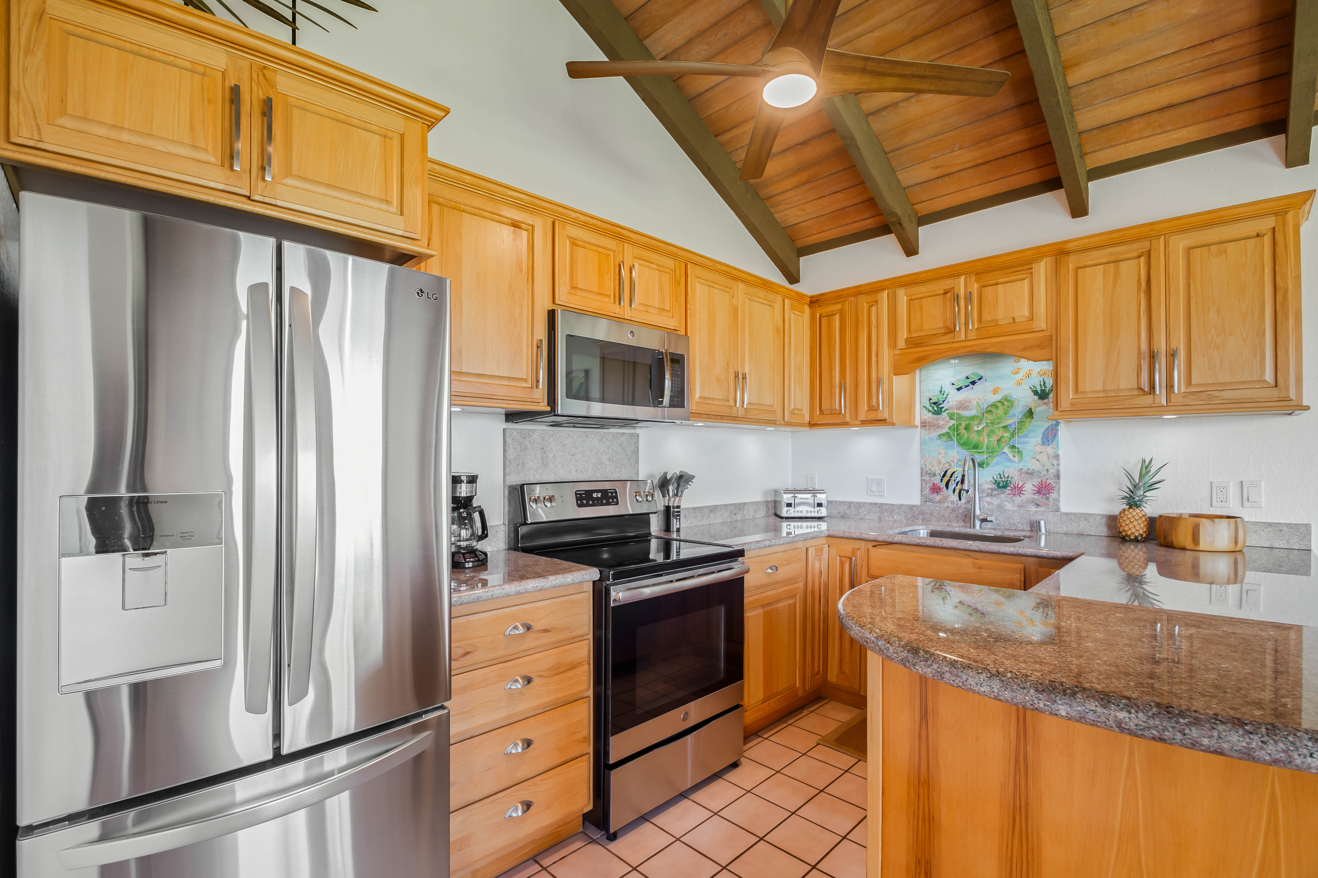 1901 Poipu Road, Unit 633 Koloa, HI 96756 - Photo 11 of 30 a kitchen with stainless steel appliances granite countertop a refrigerator sink and stove