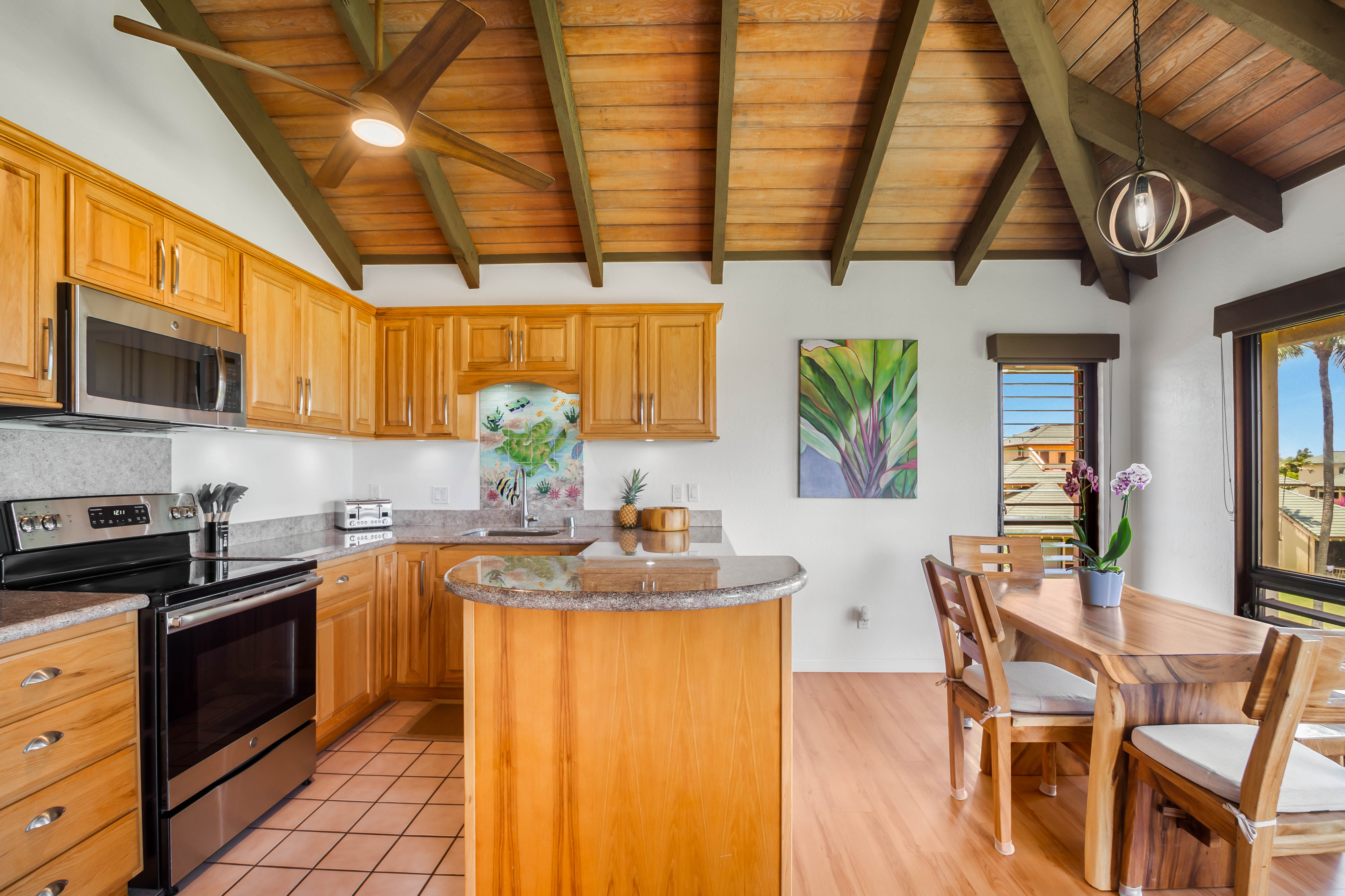 1901 Poipu Road, Unit 633 Koloa, HI 96756 - Photo 12 of 30 a kitchen with stainless steel appliances granite countertop a sink a stove cabinets counter space and a window