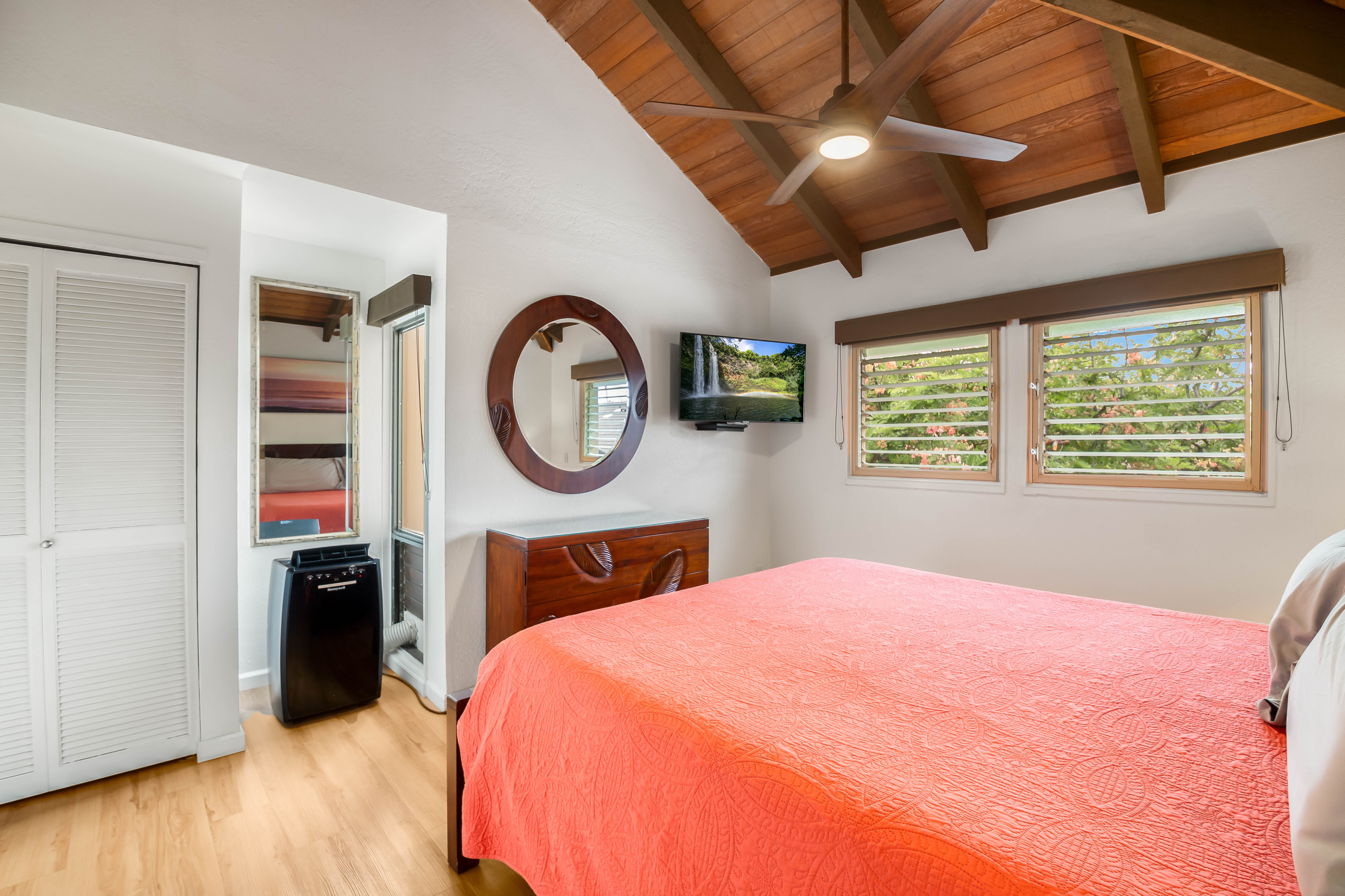 1901 Poipu Road, Unit 633 Koloa, HI 96756 - Photo 14 of 30 a bedroom with a bed a clock and a window
