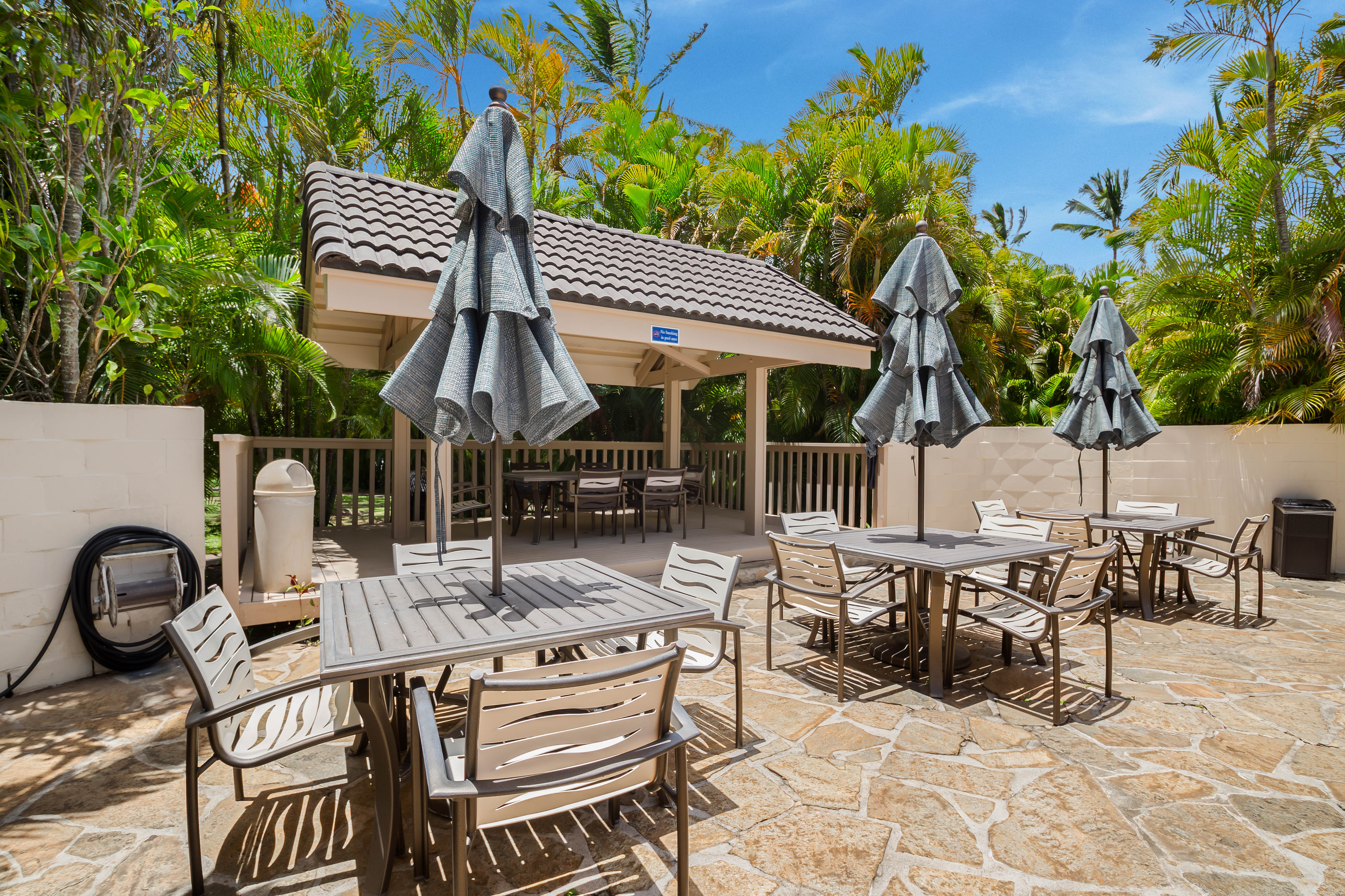 1901 Poipu Road, Unit 633 Koloa, HI 96756 - Photo 27 of 30 a patio with table and chairs and potted plants
