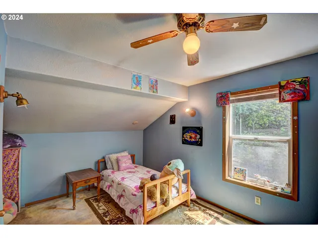 a bedroom with furniture and a window